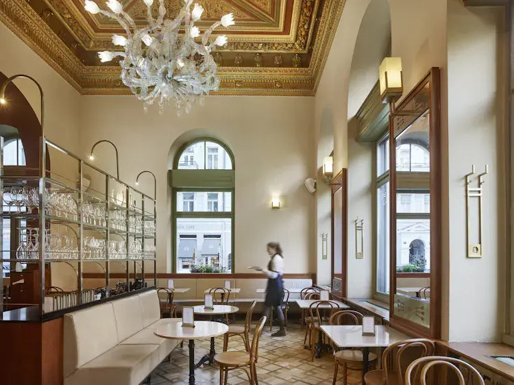 Interior of Café Savoy with historic chandeliers.