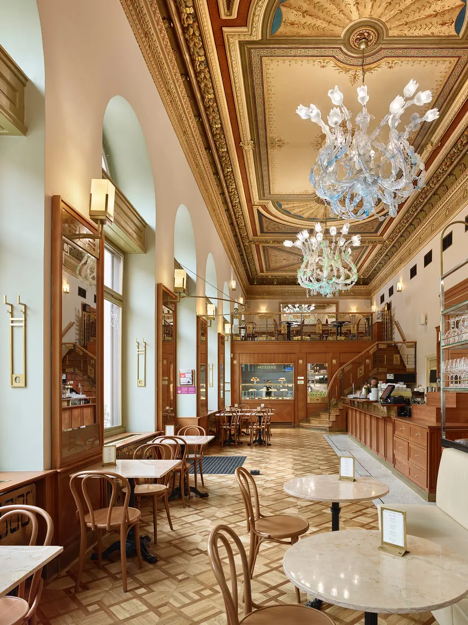 Interior of Café Savoy with historic chandeliers.